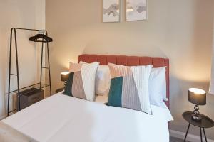 a bedroom with a bed with white sheets and pillows at Host & Stay - Endeavour Apartments in Whitby