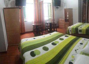 Ένα ή περισσότερα κρεβάτια σε δωμάτιο στο Hostal Sueños