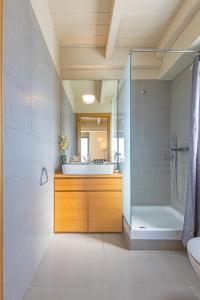 a bathroom with a tub and a sink and a shower at Sunny Penthouse,Modern Amenities+Aegean View in Rhodes Town