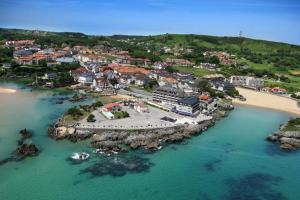 an aerial view of a town on the beach at Apartamentos Playa La Arena Encinar in Isla