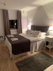 Postel nebo postele na pokoji v ubytování Hotell Kaprifol