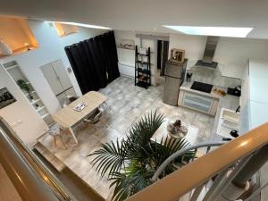 an aerial view of a living room and kitchen with a table at LOVE Suites & SPA "Le Loft" avec Jacuzzi privatif in Médis