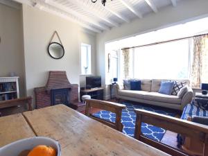 a living room with a table and a couch at Delyn Aur in Cardigan