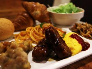 a plate of food with sausage and other foods at Kuretake-Inn Central Hamamatsu in Hamamatsu