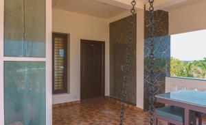 a room with a table and a glass wall at Pranaav Beach Resort in Pondicherry