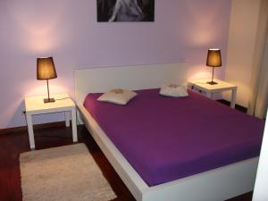 1 dormitorio con 1 cama grande y 2 mesitas de noche en Apartamento Capela, en Funchal