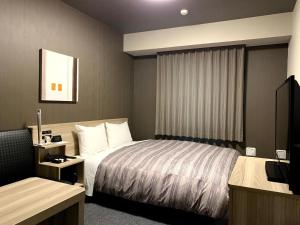 Ένα ή περισσότερα κρεβάτια σε δωμάτιο στο Hotel Route-Inn Nihonmatsu