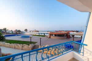 a view of the pool from the balcony of a resort at Noras Beach Hotel in Port Said