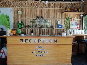 a reception desk in a store with a sign on it at Namthip Homebeach in Baan Tai