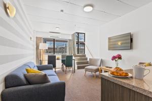 a living room with a couch and a table at Heart of Queenstown in Queenstown