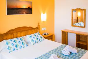 Postel nebo postele na pokoji v ubytování Sagitario Vista Playa II Apartamentos