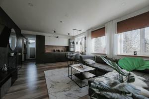 a living room with a couch and a table at Pinska Guesthouse Cozy Apartment in Viljandi