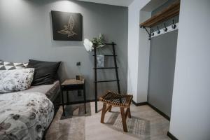 a bedroom with a bed and a ladder and a table at Pinska Guesthouse Apartment in Viljandi