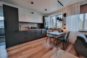 Pinska Guesthouse Apartment في فيلجاندى: مطبخ وغرفة طعام مع طاولة وكراسي