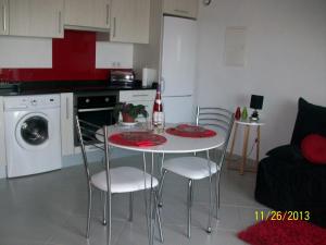 a small kitchen with a table and chairs in a room at Appartement Larraburuko-Borda in Sare