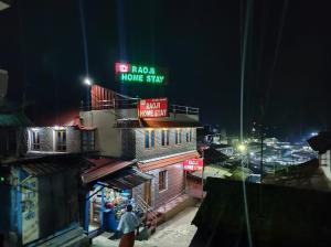 a sign on top of a building at night at RAOJI Home Stay in Vālpārai