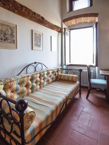 a couch sitting in a room with a window at B&B Locanda San Michele in Corciano