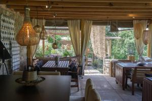a living room with a table and chairs at Aux Lodges du Mas de Nadal in Sauliac-sur-Célé