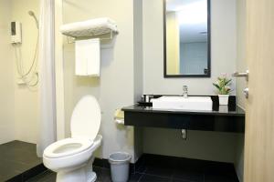 a bathroom with a toilet and a sink at Sleep Box by Miracle -Booked on Hourly Basis in Bangkok