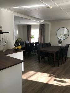 a dining room with a table and black chairs at Hotell Kaprifol in Hunnebostrand