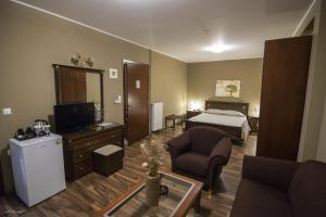 a living room with a room with a bed and a television at Vienni in Orestiada