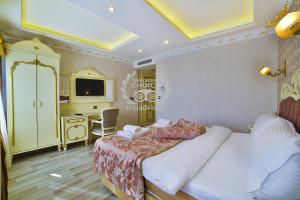 a bedroom with a bed and a desk and a tv at Nayla Palace Hotel-Special Category in Istanbul