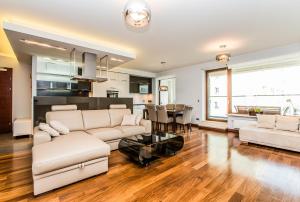 a living room with a couch and a table at EXCLUSIVE Aparthotel in Warsaw