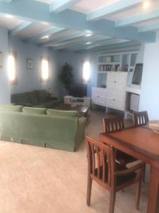 a living room with a couch and a table at Amazing in front of the sea apartment in Comarruga