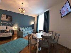 a living room with a dining room table and a couch at 92 Residence in Braşov