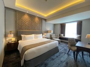 Postel nebo postele na pokoji v ubytování Sutasoma Hotel