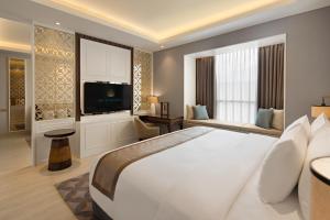 Tempat tidur dalam kamar di Sutasoma Hotel