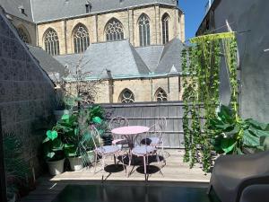 un patio con mesa y sillas frente a un edificio en WELLNESS LOFT with Sauna, Jacuzzi, Roof Terrace & Amazing View, en Amberes