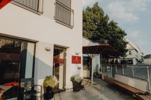 a balcony of a building with a storefront at Stadt Land Fluss New Apartments by Zollhaus in Forchheim