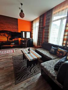 a living room with a couch and a table at Hotel Africa in Haskovo