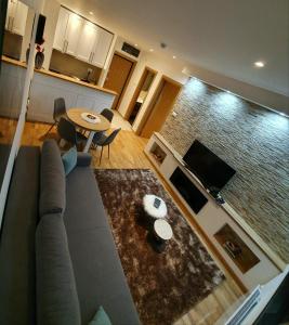 una sala de estar con un sofá y una mesa en Vila Irina Kopaonik - Apartman IN, en Kopaonik