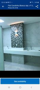 a picture of a bathroom with a tub and sink at Flat no Hotel Cavalinho Branco in Águas de Lindóia