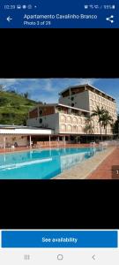a picture of a building with a swimming pool at Flat no Hotel Cavalinho Branco in Águas de Lindoia
