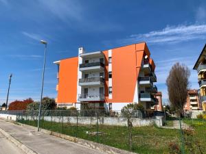 an orange and white building on the side of a street at Vicenza City Apartments 2 in Vicenza