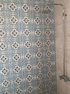 a bathroom with a tiled floor with a shower curtain at Beautiful and cozy duplex in the heart of Cairo in Cairo