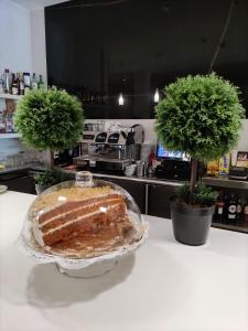 a piece of cake on a table in a kitchen at Hotel Ciudad de Navalcarnero in Navalcarnero