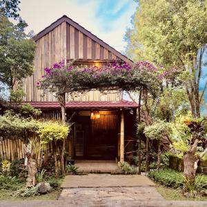 a house with flowers on the front of it at Munduk Clove in Munduk