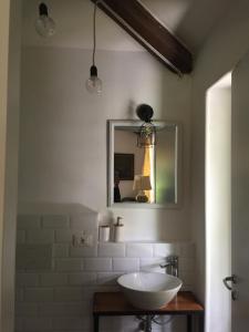 a bathroom with a sink and a mirror at Villa Cesarina, Vallio Terme , Salo’ in Vallio Terme