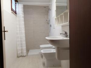 a white bathroom with a sink and a toilet at orlando in Porto Garibaldi +26 photos