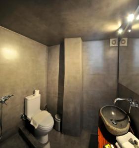 a bathroom with a toilet and a sink at Mykonos Loft in Mikonos