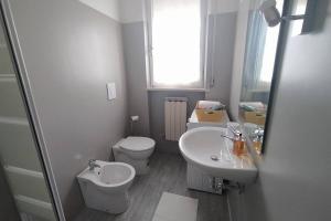 a white bathroom with a toilet and a sink at CLALU_2 - appartamento Senigallia in Senigallia