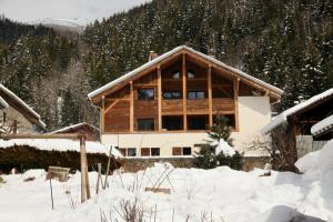 a large wooden house in the snow at La Pieuca in Les Contamines-Montjoie