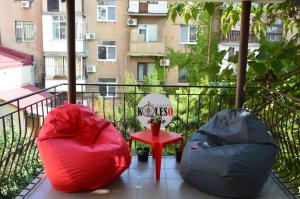a balcony with two bean bags and a red table at hostel Koleso in Odesa
