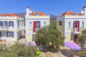 a group of houses with an umbrella in front of them at Villas Thassos in Limenaria