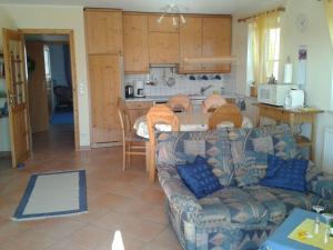 a living room with a couch and a kitchen at Ferienwohnung-Gelb in Schönberger Strand