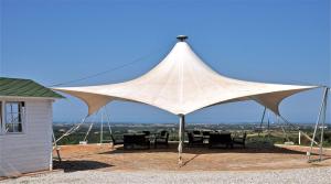 a large white tent with tables and chairs under it at Agriturismo Tenuta Pakravan Papi in Riparbella